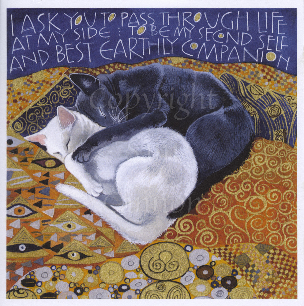 Two cats, one black and one white, lie sleeping on a bed. The black cat is curled up against the back of the white cat, with one leg over the white cat's shoulder. The bed is covered with orange and yellow swirly and geometric patterns, and the inscription, written in white against dark blue at the top of the design, reads, I ask you to pass through life at my side: to be my second self and best earthly companion.