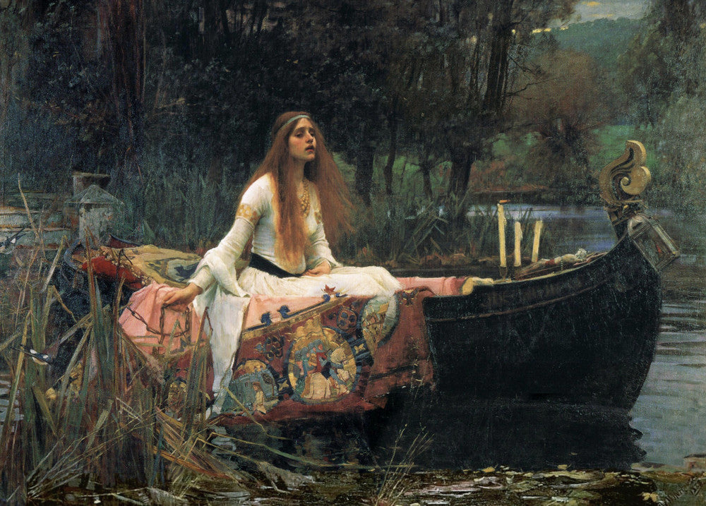 A young woman with long red hair and wearing a long, white mediaeval-style dress sits in a small wooden boat. A large and intricately decorated red and pink blanket sits inside the boat and over the sides. Candles, one lit, sit on the bow. A dark line of trees can be seen in the background. The woman holds the mooring chain in her hand, preparing to cast off.