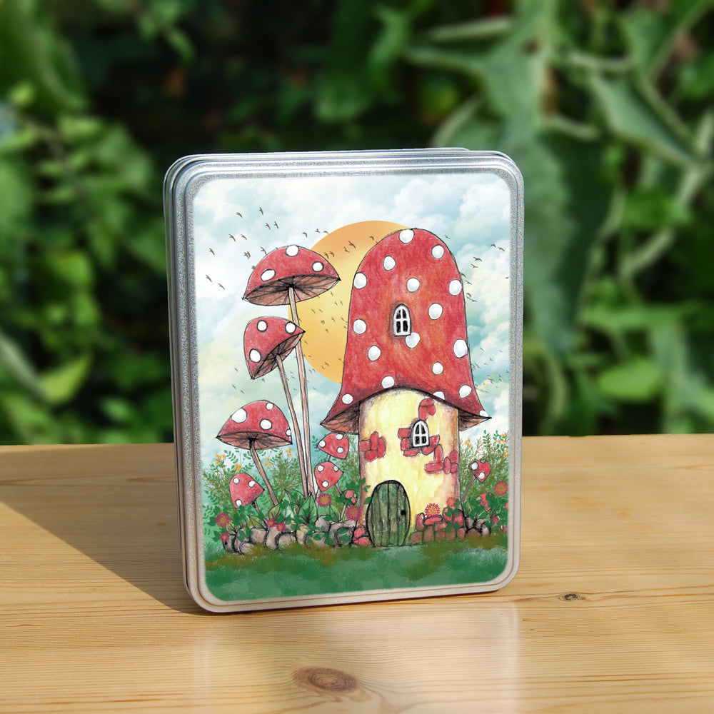 A cream toadstool house with red and white spotted roof, white curved windows, and an oval green door at the bottom. A low stone wall, entwined with leaves and red flowers, extends to each side, behind which is a mass of tall plants, several tall red toadstools on thin stems. An orange sun rises behind the house against a pale cloudy sky, and a flock of birds flies by.