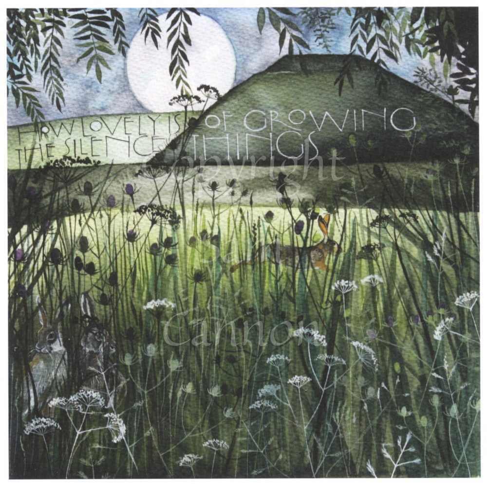 Long grass and flower stems in the foreground partially obscure the view beyond, where a hare leaps across a sunlit field in front of a tall grassy hill with a pale sun rising behind against a mottled blue sky. Two hares sit in the long grass, and leafy branches frame the view from above.