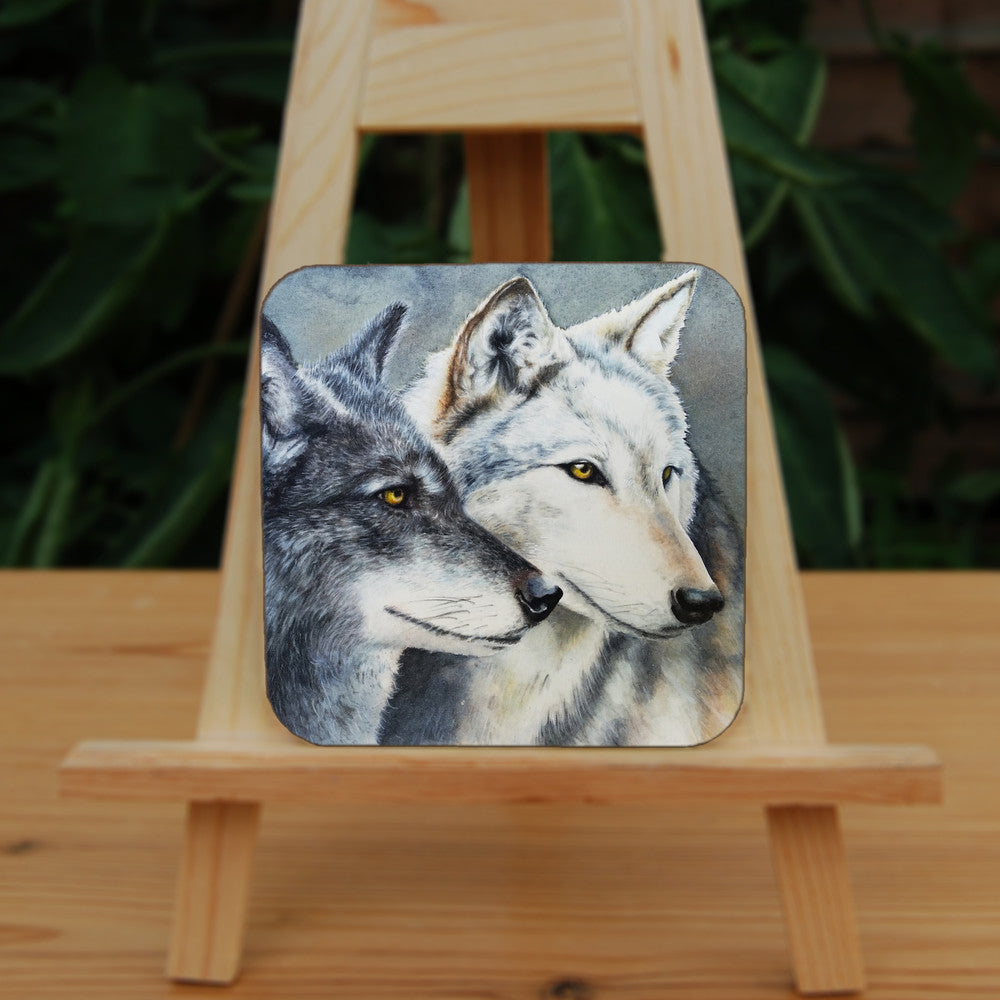 Two grey wolves face to the right, their heads close together. Only the heads of the wolves are shown.