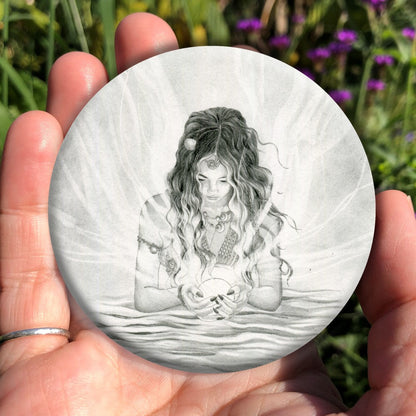 Black and white pencil drawing of a young woman with long dark hair standing waist-deep in water. In her cupped hands she holds a glowing white sphere from which streams of light emerge and flow in all directions. Her face, lowered toward the sphere, is lit by the glow.