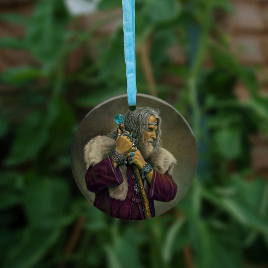 A man with long grey hair and a beard leans on his staff, looking intently to the right. He is wearing a deep purple coat with a pale-coloured fur mantle, and many silver bracelets and rings. A silver pentagram can be glimpsed from behind his staff. The top of the wooden staff has a large, turquoise jewel at the top.