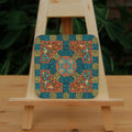 An intricate design incorporating dozens of Celtic knots. Colours are orange, beige and blue.