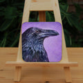 A side view of the head and neck of a raven with lots of feather detail. The raven is coloured black with purple shading, and the background is mottled purple.