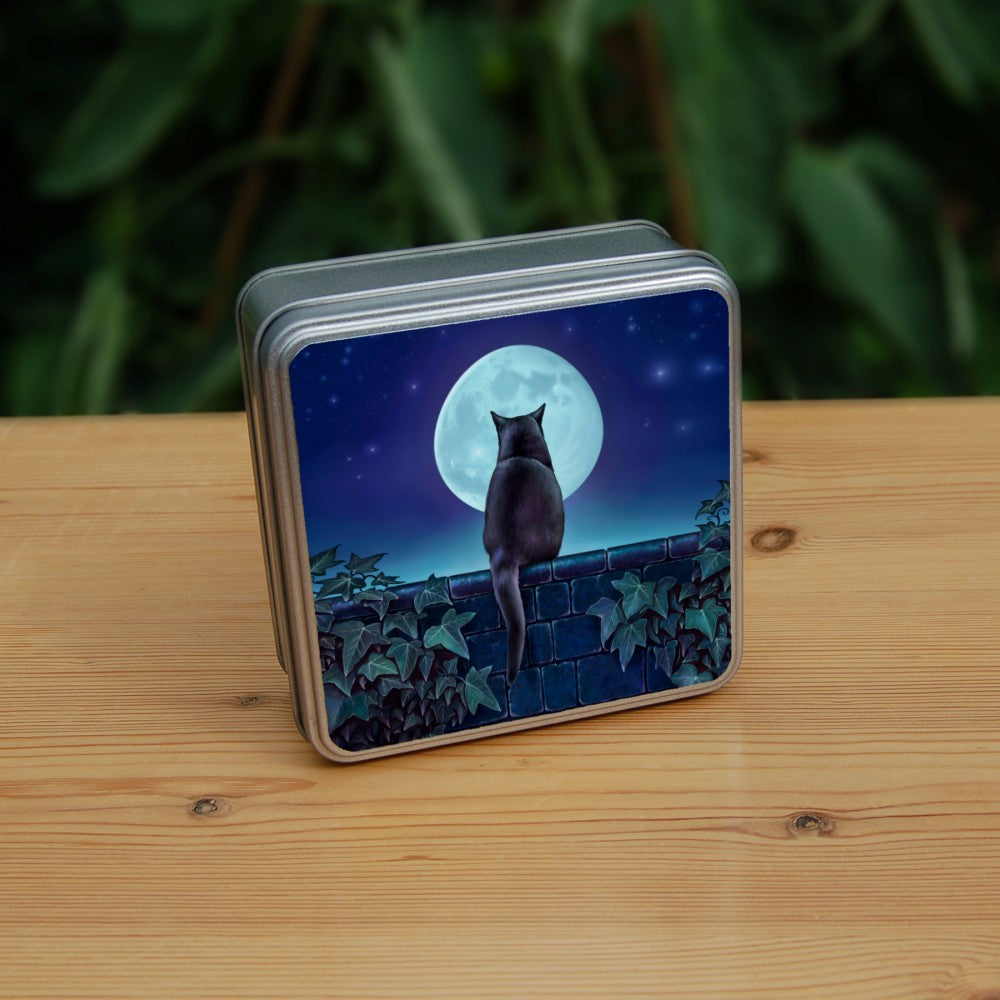 A black cat sitting on a brick wall at night looking towards the full moon. There is ivy on the wall either side of the cat. Colours are mostly deep blues and greens.