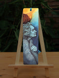 A rectangular bookmark: An elderly woman facing towards the right, coloured in shades of blue and grey.
