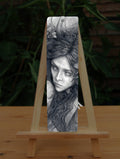 A rectangular bookmark: Pencil illustration of the head and shoulders of a young woman looking back over her shoulder. She has a mass of hair sticking out in all directions around her head and down her front. 