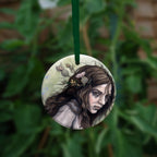 The reverse side of the ornament, showing a close-up of the woman's head.