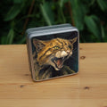 A square tin: The head and body of a snarling brown striped cat. 