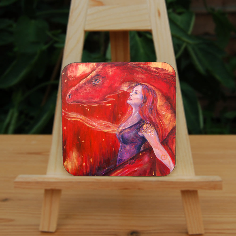A woman with long red hair and wearing a sleeveless purple dress stands in front of a red dragon. Both look to the left. A wing wraps around one side, with the head on the other. A stream of fire is emitting from the location of the woman's heart. The overall design colour is red.