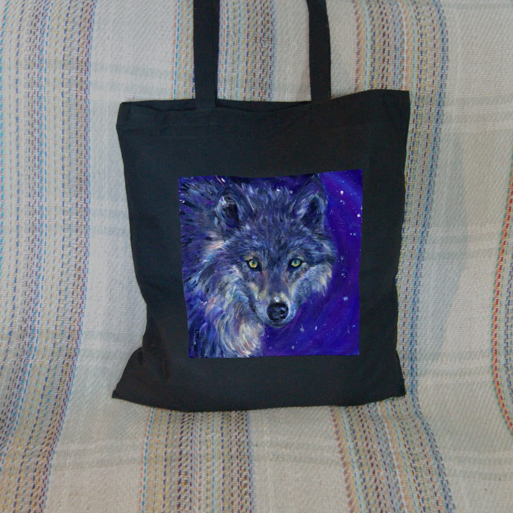 The head of a wolf, looking directly at the viewer. The overall colour of both the wolf and the background are shades of blue, with the exception of yellow/green eyes and flashes of paler fur around the neck.