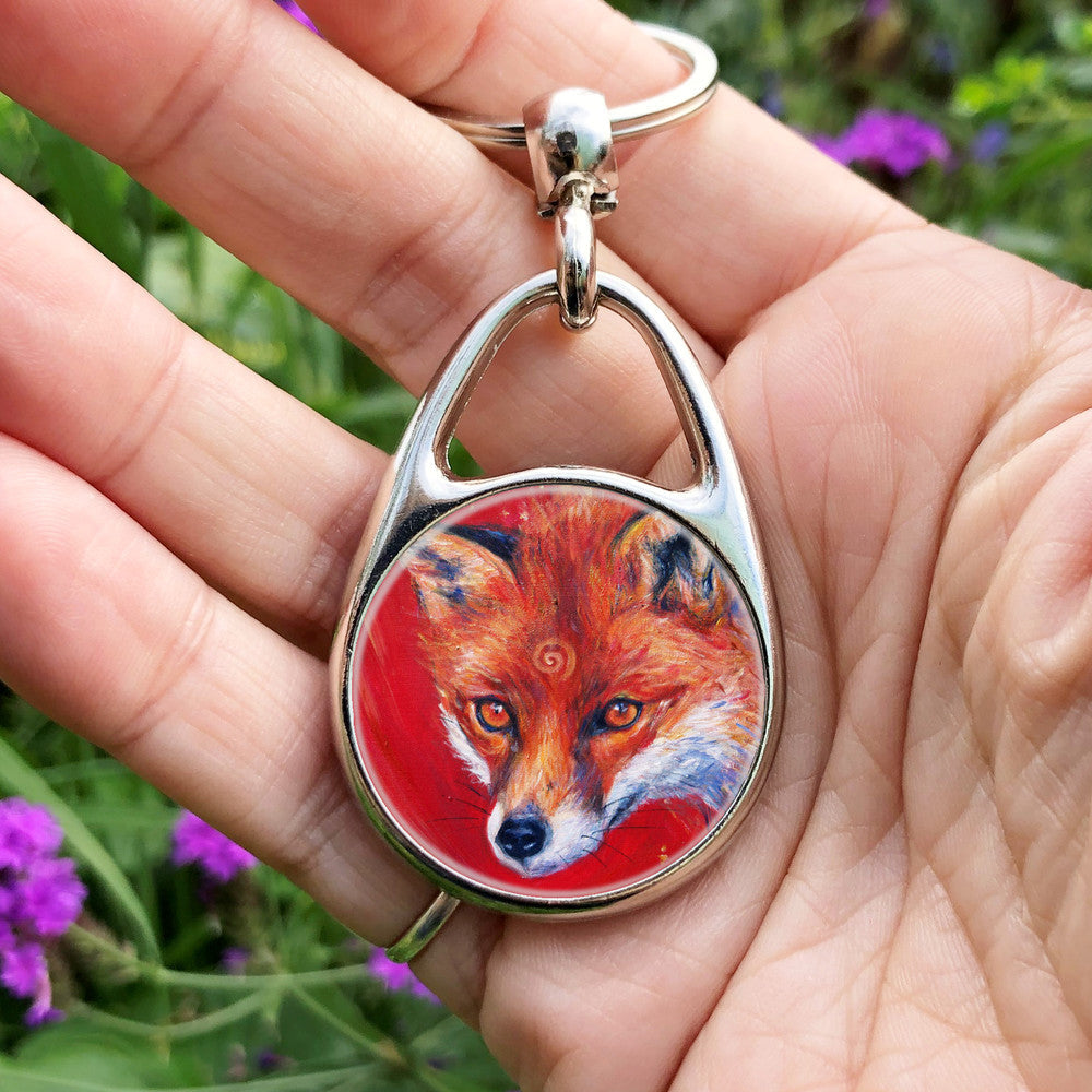 The head of a red fox looking at an angle towards the viewer, coming into the painting from the right. A pale-coloured spiral is coiled on their forehead. The background is red.