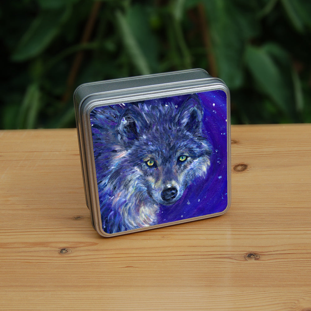 The head of a wolf, looking directly at the viewer. The overall colour of both the wolf and the background are shades of blue, with the exception of yellow/green eyes and flashes of paler fur around the neck.