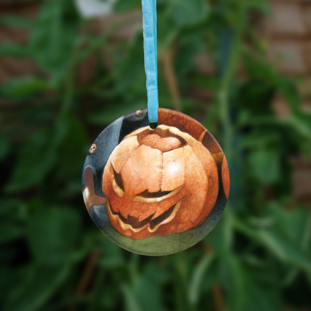 The reverse side of the image, showing just a pumpkin with a face cut into it.