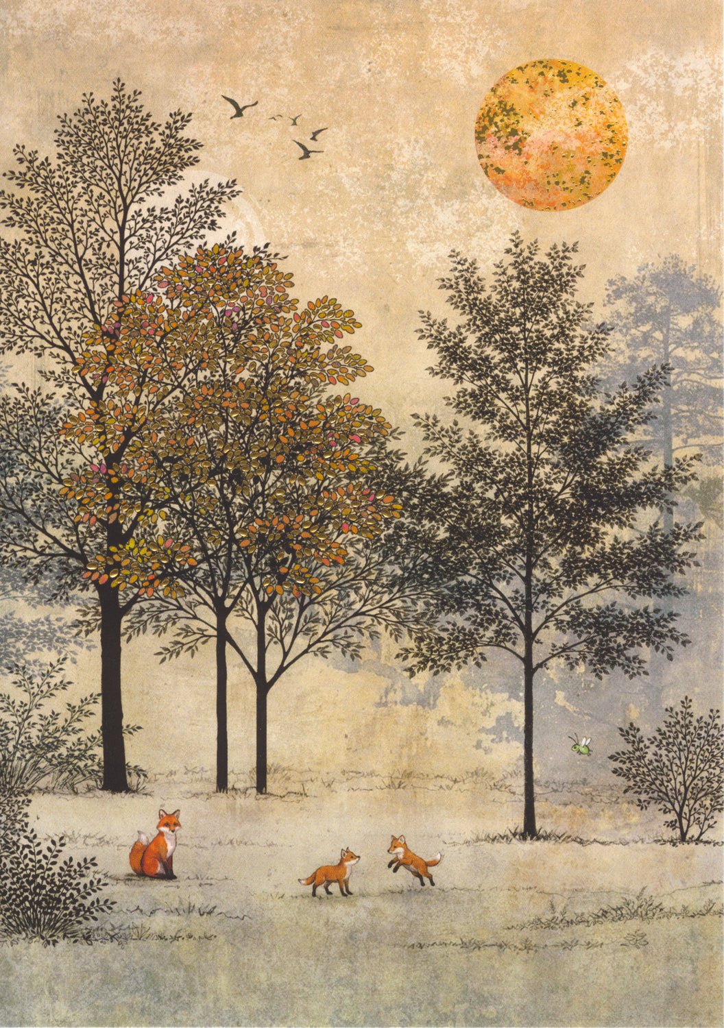 A red fox sits in a field watching their two kits playing. A group of autumnal trees, one with red leaves, stand behind them, and shrubs to the left and right. The sun shines above, and a group of birds fly over the trees. Overall colours are tan, brown and orange.