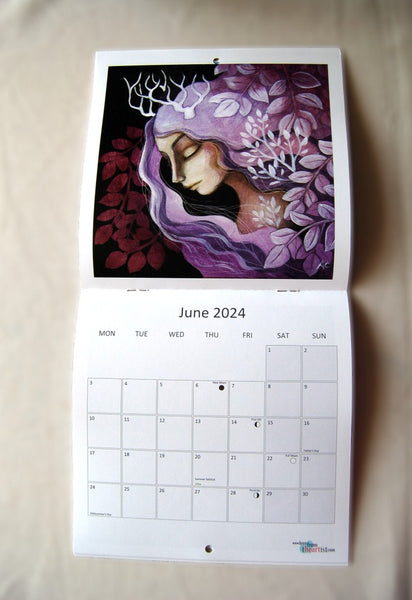 Page for June 2024, showing a woman with deep pink hair and small antlers surrounded by leaves. The calendar opens up to show the image at the top, with the calendar section below.