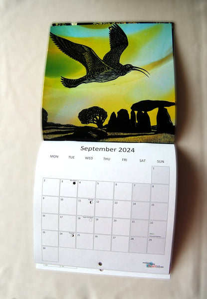 Page for September 2024, featuring a curlew flying over a Neolithic burial chamber in a field. The calendar opens up to show the image at the top, with the calendar section below.