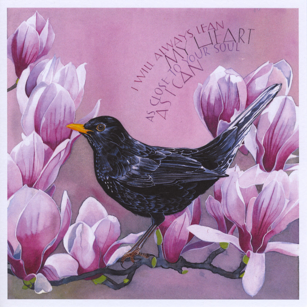 A black bird with an orange beak perches on a branch surrounded by large pink flowers. A curved inscription in the top right-hand quarter reads, "I will always lean my heart as close to your soul as I can". The background is in shades of pink.