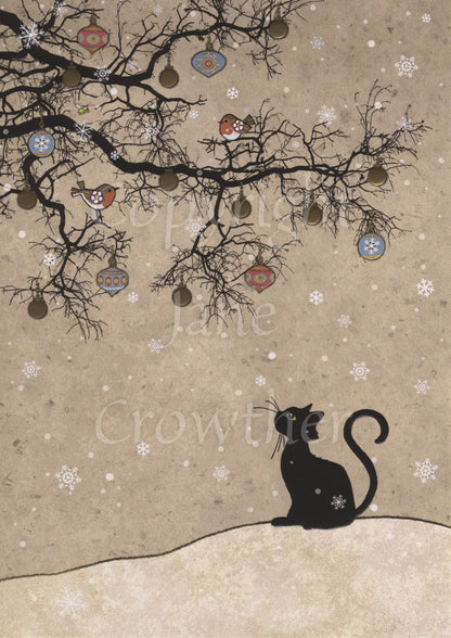 The silhouette of a black cat sitting looking up towards the silhouette of a leafless tree. The tree is decorated with colourful baubles. Two robins sit in the tree, and snow falls all around. The background is shades of beige.