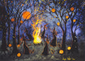 The silhouettes of five witches in long black dresses, pointed hats, and outlined in gold, dancing around a large fire at night. Black cats sit near their feet. They dance in a grassy clearing surrounded by bare trees with jack-o-lanterns hanging from the branches. Embers from the fire sparkle upwards and around the trees, and glowing orange full moon shines through the trees.