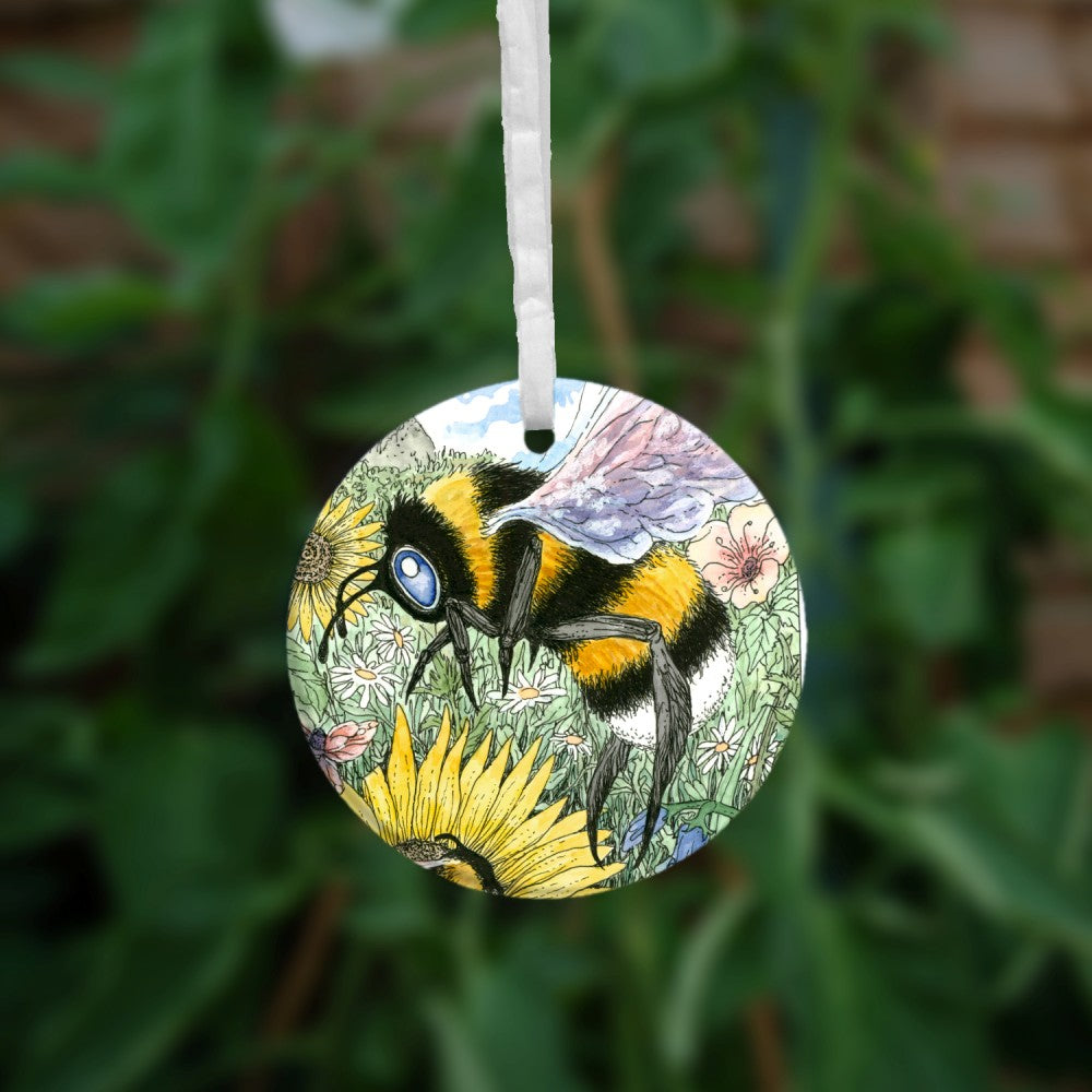 A large bee descends towards a flower.