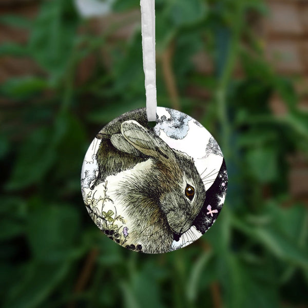 The second side of the ornament showing just the head of one of the hares.