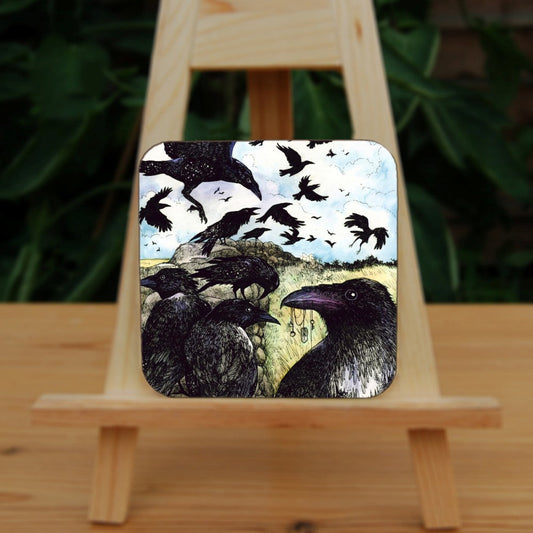 A large flock of ravens sit on and fly around a drystone wall surrounded by yellow-green grassy fields. The blue sky is broken with white clouds. In the foreground a raven holds a string of tokens in its beak, including a pentagram, key and Teiwaz rune.