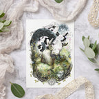 Nature-themed greeting card with hares on a textured surface with greenery