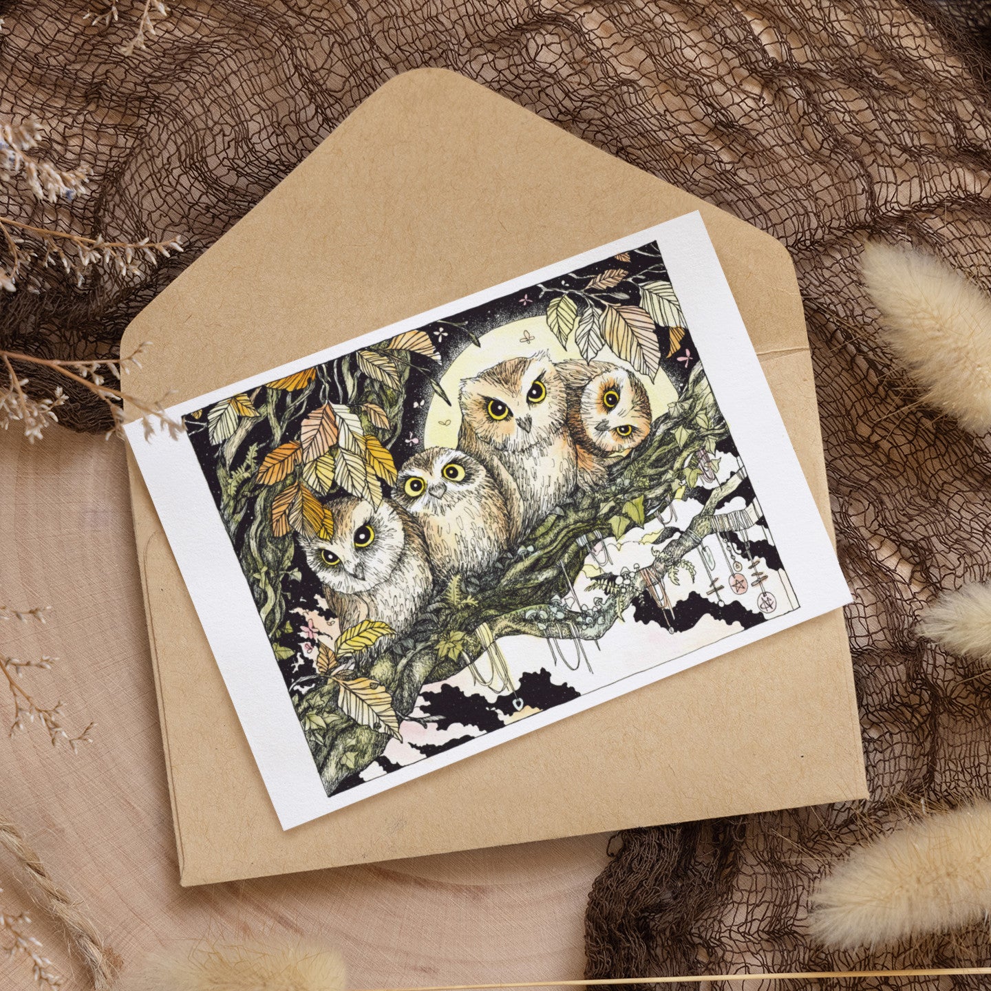 Greeting card with owl design on a brown envelope against a textured background