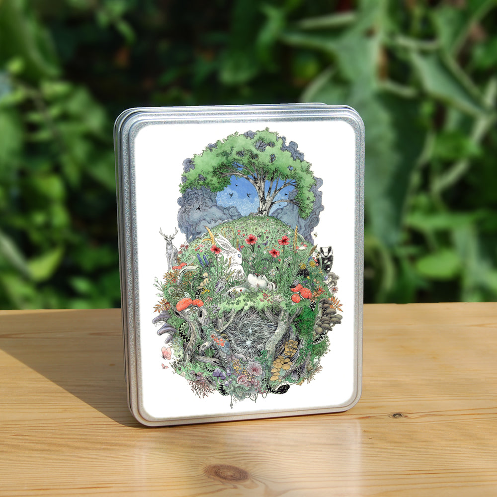 A roughly oval design, topped with a tree in full leaf, surrounded by clouds, but clearing to blue in the centre, and swifts wheeling all around. Beneath, the top half of the oval is a flower-filled meadow. A stag and badger stand either side, and a hare, blackbird, mouse, and other creatures are nestled within. The head and shoulders of a young woman lying on her back rise from the ground. Beneath her, the bottom half of the oval is a mass of twisting roots, branches, leaves, fungi and toadstools ...