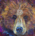 The head of a bear looking directly at the viewer. A pale-coloured spiral is coiled at their forehead, opening upwards. Their fur is a mixture of reds, golds and browns, with a pale nose.