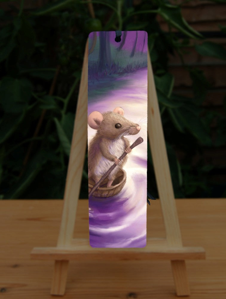 A cute brown mouse, standing in half a nut shell and holding a twig shaped like an oar, drifts down a stream. Trees line the side of the stream. Colours are purples and greens.