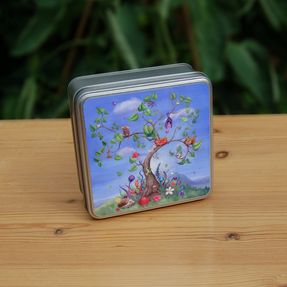 A tree with a curved trunk, curly branches and large green leaves, rises against a blue sky. Sitting on the branches are number of animals, including a fox, bat, spider, squirrel and owl. Also a tiny person holding an umbrella, and a very small cow! A fairy door can be seen at the foot of the tree, along with a hedgehog and colourful flowers and toadstools.