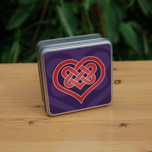 A heart shape which forms into a Celtic knot from the top and into the centre of the heart. The design is red with a white edge. The background is purple.