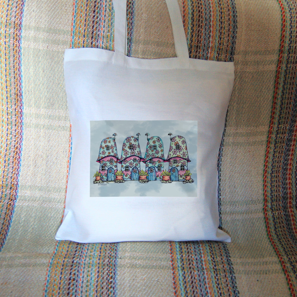 Four pink and blue / green toadstool houses stand in a row. The roofs and walls of all four are liberally decorated with simple flower designs have curved windows (two stories, plus a window in the roof) and have curved blue front doors. Tiny toadstool-shaped chimney pots protrude from each roof, and red planters surrounded by stones and with leafy plants growing from each sit between each house. The background is a mottled pale blue.