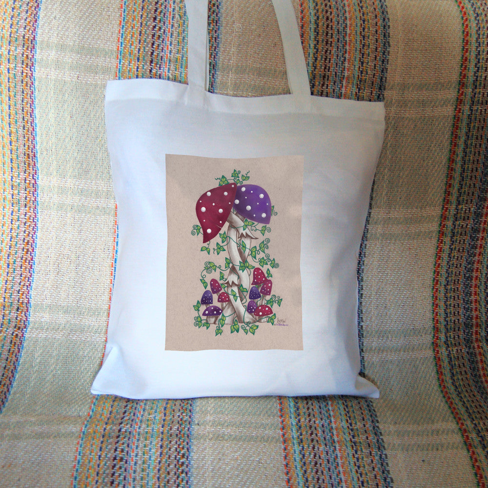 Two toadstools with long pale stems are twined together. The cap of one of them is red with white spots, the other purple with white spots. More small toadstools are dotted around the foot of the pair, and leafy green tendrils twine around and up the main pair. The background is a mottled beige colour.