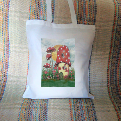 A cream toadstool house with red and white spotted roof, white curved windows, and an oval green door at the bottom. A low stone wall, entwined with leaves and red flowers, extends to each side, behind which is a mass of tall plants, several tall red toadstools on thin stems. An orange sun rises behind hte house against a pale cloudy sky, and a flock of birds flies by.