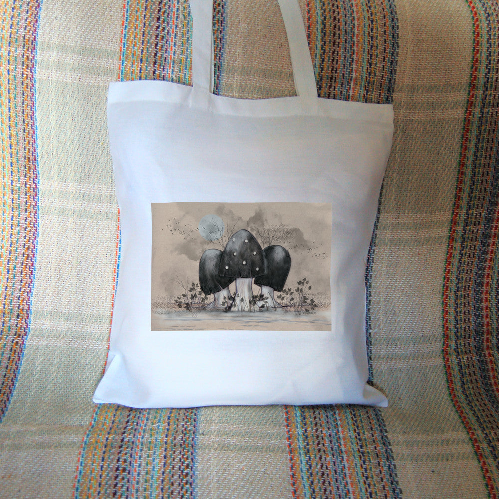 A cluster of toadstools with black caps. The cap of the centre toadstool has white spots. They're surrounded by the silhouettes of leafy plants, and a mist lies low on the ground. Above them a silvery full moon shines, and a flock of birds flies across. The background is a mottled beige.