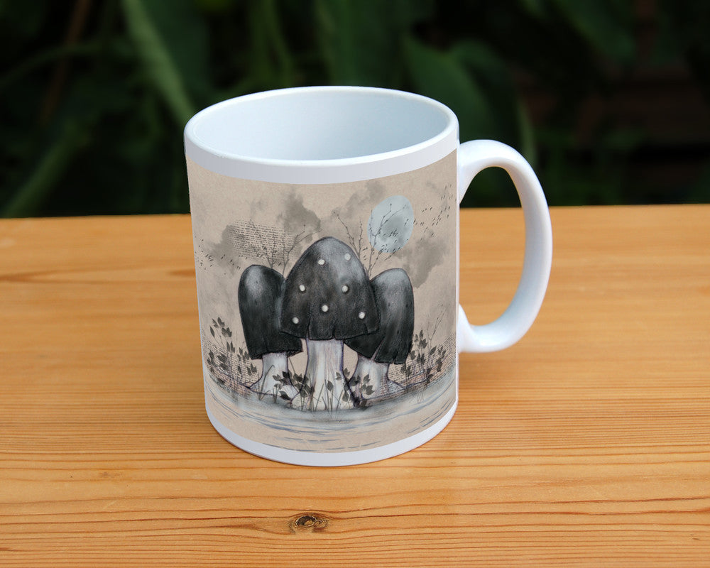 A cluster of toadstools with black caps. The cap of the centre toadstool has white spots. They're surrounded by the silhouettes of leafy plants, and a mist lies low on the ground. Above them a silvery full moon shines, and a flock of birds flies across. The background is a mottled beige.